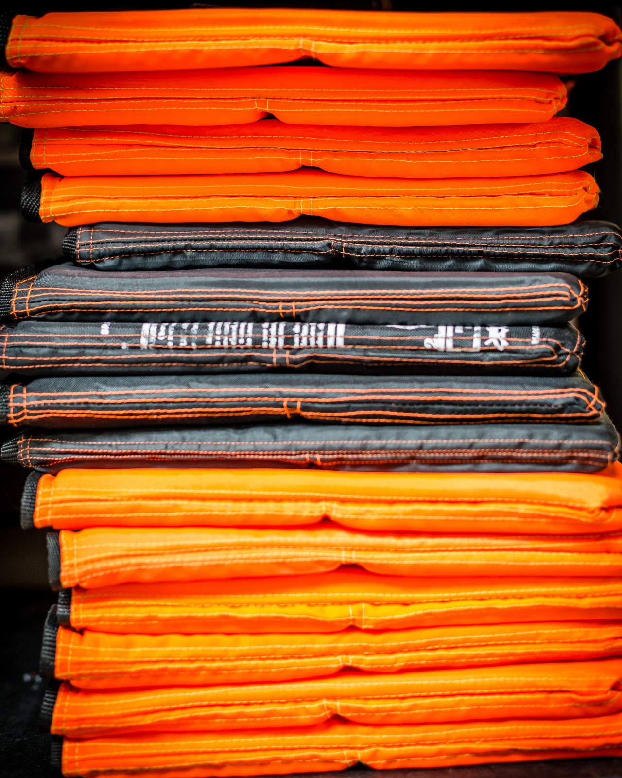 Stacks of orange and black shirts