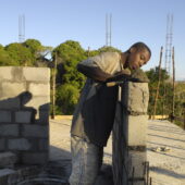 Construction worker building a wall in a new constructed home.