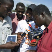 A salesman is selling a portable led lamp on solar energy at a local cattle market In Uganda