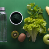 Various vegetables and fruit on a green background