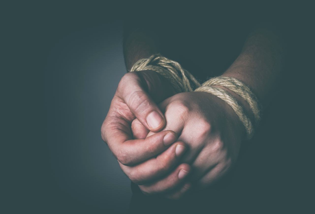 Tied hands rope bound slavery